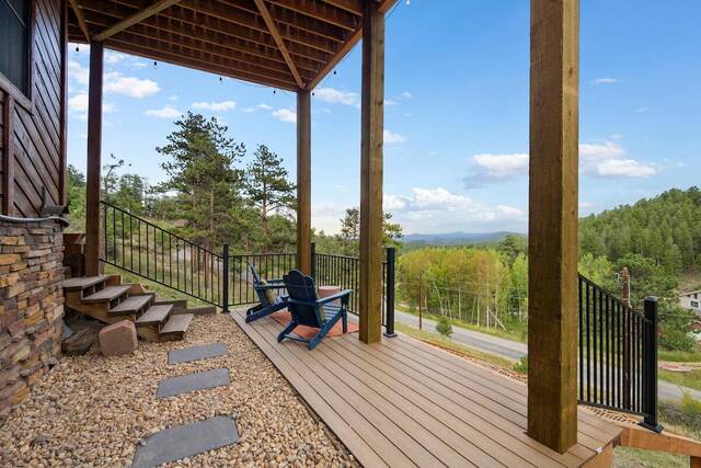 The covered deck, with stonework and an adirondack chair