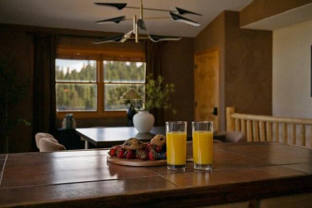 Breakfast laid on the dining table beside the view windows