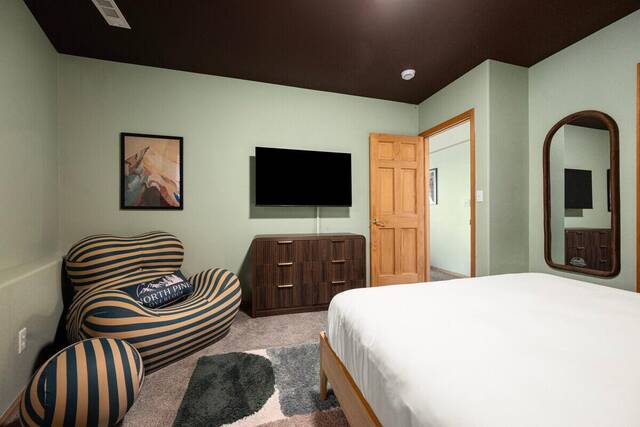 A bedroom with a bean bag chair and television