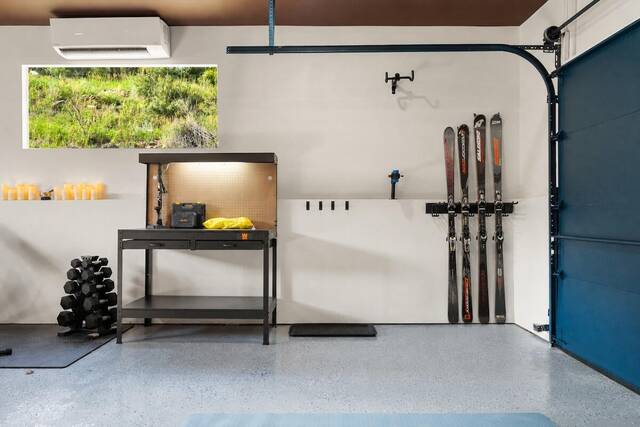 Ski storage on the garage wall beside the workbench
