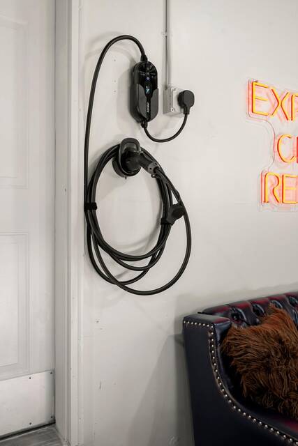 The EV charger mounted beside the garage door